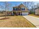 Traditional two-story home with brick and siding, a two-car garage, and a spacious front lawn at 4870 Odum View Ln, Cumming, GA 30040
