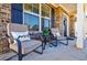 Inviting front porch with comfortable seating, decorative pillows, and plants at 4870 Odum View Ln, Cumming, GA 30040