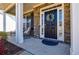 Covered front porch with a decorated front door, accent plants and room for seating at 4870 Odum View Ln, Cumming, GA 30040
