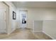 Bright hallway with carpeted floors, neutral walls, white trim, and open doorways at 4870 Odum View Ln, Cumming, GA 30040