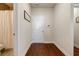 Hallway featuring hardwood floors that leads to a white door and a full bath with shower at 4870 Odum View Ln, Cumming, GA 30040