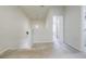 Light and airy hallway featuring carpeted floors, white walls, and a hanging light fixture at 4870 Odum View Ln, Cumming, GA 30040