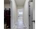 Tiled hallway leading to walk-in closet and bathroom with tub and shower at 4870 Odum View Ln, Cumming, GA 30040