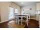 Cozy eat-in kitchen area featuring dark hardwood floors and a door leading to the backyard at 4870 Odum View Ln, Cumming, GA 30040