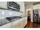 Kitchen with granite countertops, stainless steel appliances, and convenient pantry access at 4870 Odum View Ln, Cumming, GA 30040