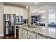 Kitchen with granite countertops and stainless steel appliances, opens to the dining area at 4870 Odum View Ln, Cumming, GA 30040