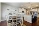Bright kitchen features white cabinetry, granite countertops, stainless steel appliances and eat-in dining area at 4870 Odum View Ln, Cumming, GA 30040