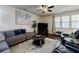 Comfortable living room with a sectional sofa, television, and lots of natural light from the windows at 4870 Odum View Ln, Cumming, GA 30040