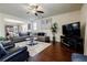 Open-concept living room features hardwood floors, a sectional sofa, and stylish decor at 4870 Odum View Ln, Cumming, GA 30040