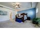 Spacious main bedroom featuring blue accent wall and sizable bed at 4870 Odum View Ln, Cumming, GA 30040