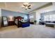 Luxurious main bedroom with a bed, sitting area, carpeted floors, and tray ceiling at 4870 Odum View Ln, Cumming, GA 30040