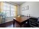 Well-lit home office with large desk, comfortable seating, and natural light at 4870 Odum View Ln, Cumming, GA 30040