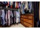 Walk-in closet with clothing racks and built-in dresser storage at 4870 Odum View Ln, Cumming, GA 30040