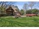 Expansive backyard featuring a stone patio with an outdoor dining area and a covered porch at 710 E Northway Ln, Atlanta, GA 30342