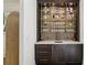 Stylish bar area with marble countertop, dark wood cabinets, and gold shelving at 710 E Northway Ln, Atlanta, GA 30342
