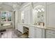 Elegant bathroom featuring marble countertop, custom cabinets, and shuttered windows at 710 E Northway Ln, Atlanta, GA 30342