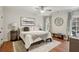 Comfortable bedroom with a ceiling fan, hardwood floors, and natural light at 710 E Northway Ln, Atlanta, GA 30342