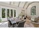 Elegant dining room with large windows, vaulted ceilings, and a statement chandelier at 710 E Northway Ln, Atlanta, GA 30342