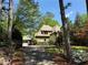 Charming brick home nestled amongst mature trees with a winding driveway at 710 E Northway Ln, Atlanta, GA 30342