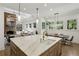 Open-concept kitchen with a large island, modern appliances, and abundant natural light at 710 E Northway Ln, Atlanta, GA 30342