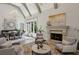 Spacious living room featuring a fireplace, large windows, and sophisticated decor at 710 E Northway Ln, Atlanta, GA 30342