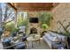 Inviting covered patio with a stone fireplace, TV, and comfortable seating at 710 E Northway Ln, Atlanta, GA 30342