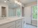 Bathroom featuring double sink vanity, tile floors, and window letting in natural light at 1628 Ruskin Way, Marietta, GA 30062
