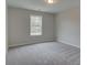Bright bedroom with neutral carpet and a view from the window at 1628 Ruskin Way, Marietta, GA 30062