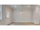 Bright dining room with modern chandelier and wood-look flooring at 1628 Ruskin Way, Marietta, GA 30062