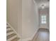 Hallway with wood-look floors leading to a door and staircase at 1628 Ruskin Way, Marietta, GA 30062