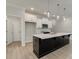 Well-equipped kitchen with a dark island, white cabinets, and stainless-steel microwave at 1628 Ruskin Way, Marietta, GA 30062