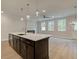 Open-concept kitchen featuring a large island, modern lighting, and ample natural light at 1628 Ruskin Way, Marietta, GA 30062