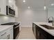 Contemporary kitchen design with white cabinets, stainless steel appliances and backsplash at 1628 Ruskin Way, Marietta, GA 30062
