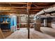 Unfinished basement with exposed beams and utilities, offering potential for customization and added living space at 2601 Semmes St, Atlanta, GA 30344