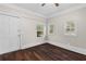 Bright bedroom boasts hardwood floors, three windows, and white trim at 2601 Semmes St, Atlanta, GA 30344