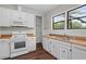 Kitchen featuring white cabinetry, wood countertops, stainless steel appliances, and bright windows at 2601 Semmes St, Atlanta, GA 30344