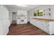 Spacious kitchen featuring white cabinetry, wood countertops, stainless steel appliances, and large windows at 2601 Semmes St, Atlanta, GA 30344