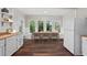 Eat-in kitchen featuring bright windows, an adjacent dining table, white cabinetry, and stainless steel appliances at 2601 Semmes St, Atlanta, GA 30344