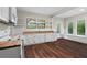 Bright eat-in kitchen with wood countertops, white cabinetry, stainless steel appliances, and large windows at 2601 Semmes St, Atlanta, GA 30344