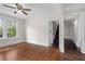 Bright living room featuring hardwood floors, a ceiling fan, and large windows offering a pleasant outdoor view at 2601 Semmes St, Atlanta, GA 30344