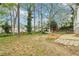Large backyard featuring mature trees, a gazebo, garden beds, and a patio area at 353 Oak Ridge Se Dr, Marietta, GA 30060