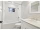 Bright bathroom with a white vanity, framed mirror, and tub with tile surround at 353 Oak Ridge Se Dr, Marietta, GA 30060