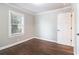 Bedroom featuring hardwood floors, white baseboards, window, and a closet door at 353 Oak Ridge Se Dr, Marietta, GA 30060