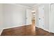 Bedroom with hardwood floors, white trim, baseboards, and a view into the kitchen at 353 Oak Ridge Se Dr, Marietta, GA 30060