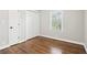Bedroom showcasing hardwood floors, a closet, a bright window, and white baseboards at 353 Oak Ridge Se Dr, Marietta, GA 30060