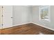 Bedroom featuring hardwood floors, white baseboards, window, and a bright closet at 353 Oak Ridge Se Dr, Marietta, GA 30060