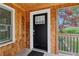 Inviting front porch with a wooden ceiling, a charming black door, and cedar shingle accents at 353 Oak Ridge Se Dr, Marietta, GA 30060