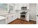 Bright kitchen with stainless steel appliances, white cabinets, and modern fixtures at 353 Oak Ridge Se Dr, Marietta, GA 30060