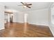 Open living area featuring hardwood floors, neutral paint, white trim, a beam, and a ceiling fan at 353 Oak Ridge Se Dr, Marietta, GA 30060