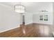 Bright living room with hardwood floors, neutral paint, white trim, a modern light fixture, and large windows at 353 Oak Ridge Se Dr, Marietta, GA 30060
